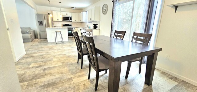 dining area with light wood-type flooring