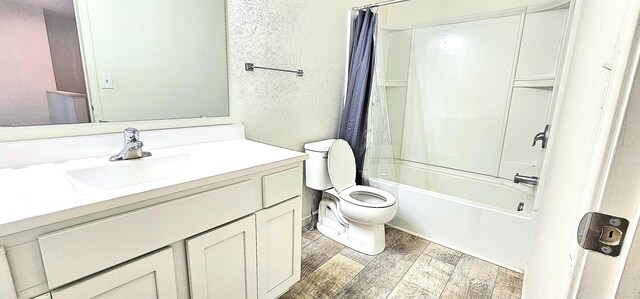 full bathroom featuring vanity, shower / bathtub combination with curtain, and toilet