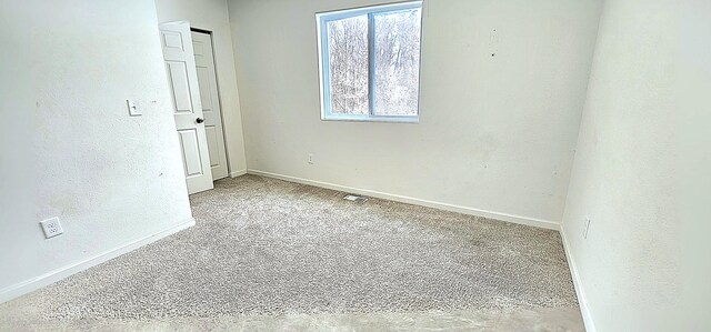 unfurnished room with light colored carpet