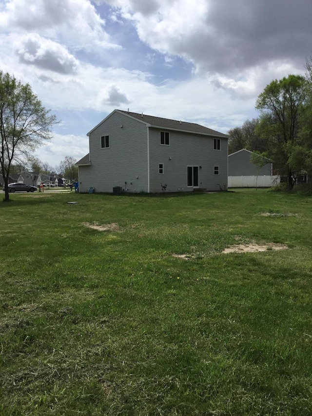 rear view of house with a lawn