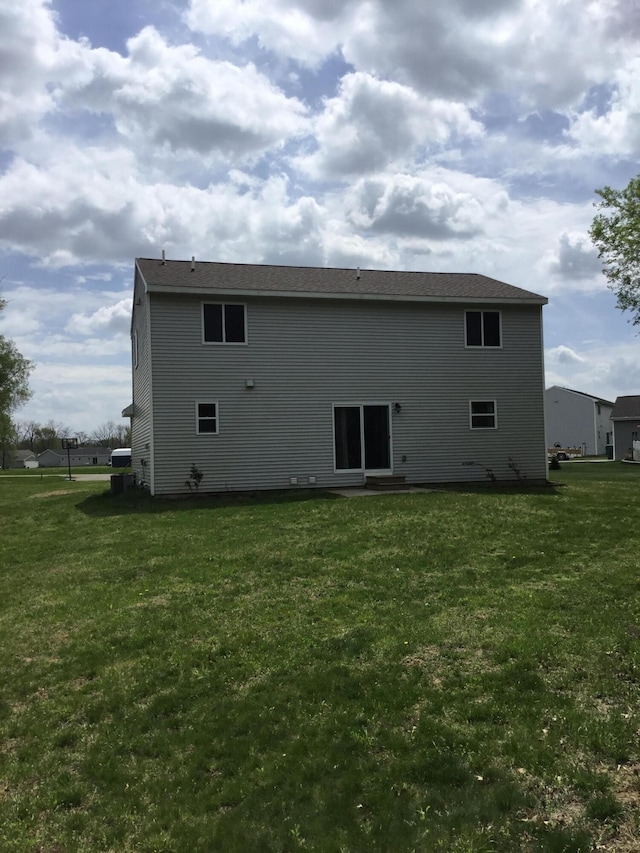 rear view of property featuring a yard