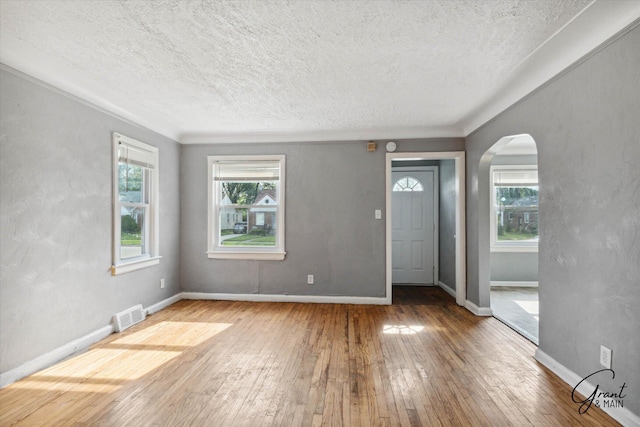 entrance foyer featuring a wealth of natural light, hardwood / wood-style floors, and a textured ceiling