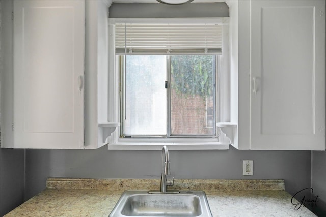 details featuring white cabinetry and sink