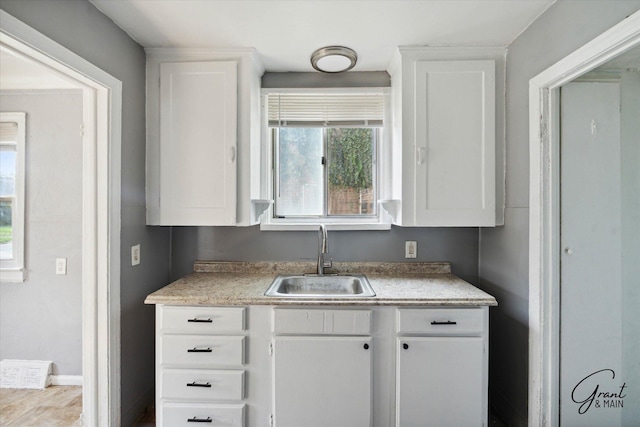 kitchen with white cabinetry and sink