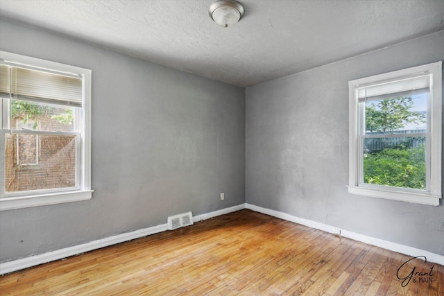 spare room with light hardwood / wood-style flooring