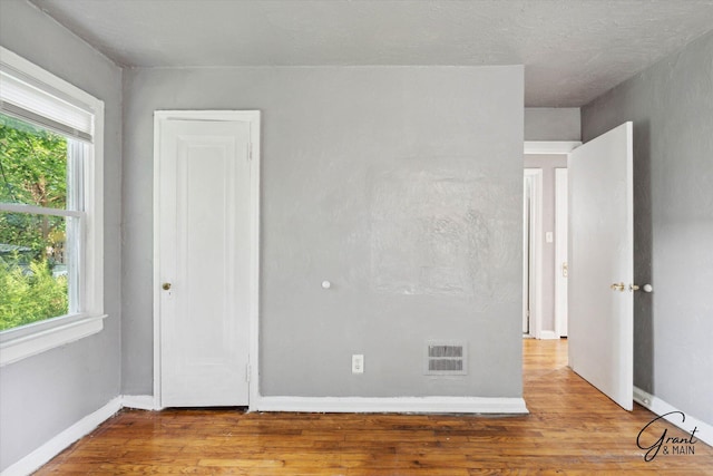 unfurnished bedroom with light wood-type flooring