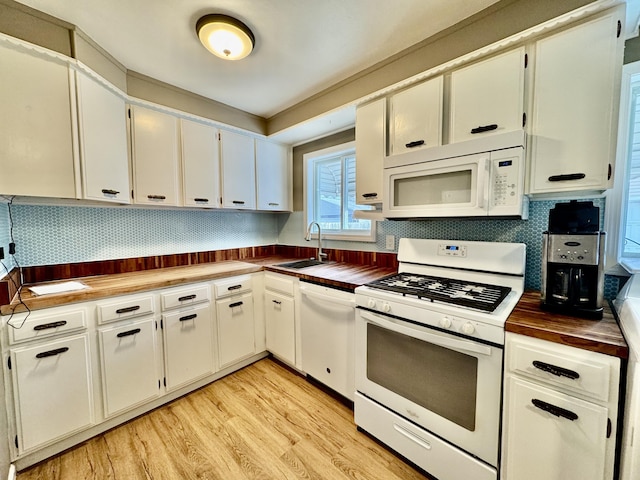 kitchen featuring sink, white cabinets, white appliances, and light wood-type flooring