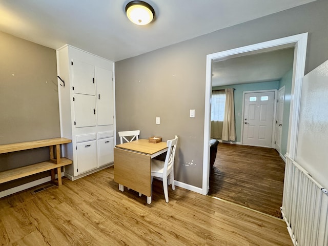 dining space featuring light wood-type flooring