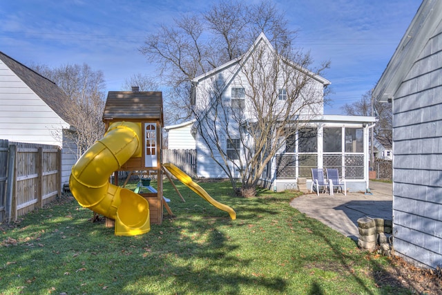 exterior space with a patio area, a sunroom, and a playground