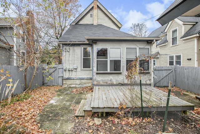 back of house featuring a wooden deck