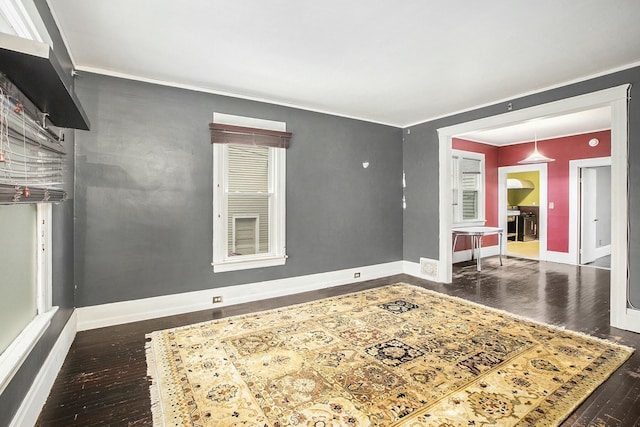 spare room with dark hardwood / wood-style flooring and ornamental molding