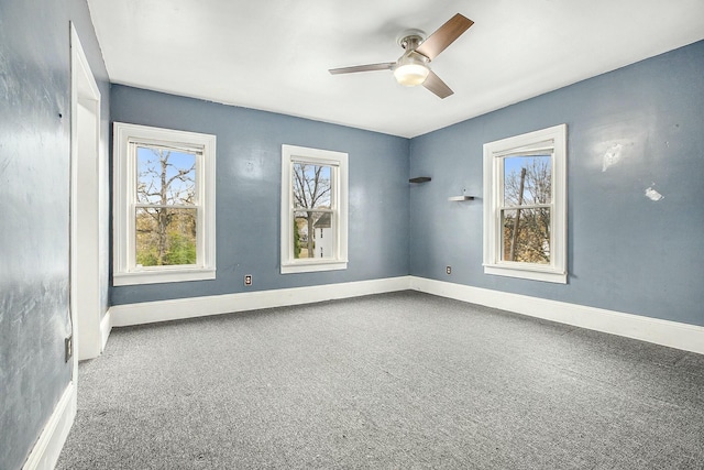 carpeted spare room with ceiling fan