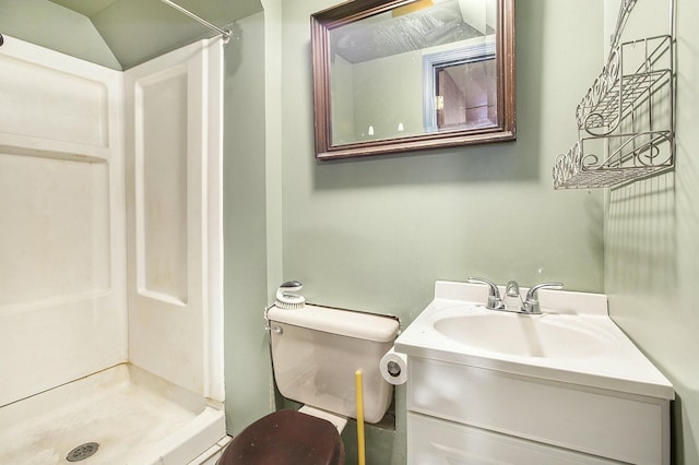 bathroom featuring vanity, toilet, a shower, and lofted ceiling