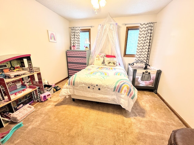 bedroom featuring carpet and a textured ceiling