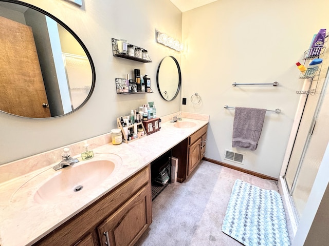 bathroom with a shower with door and vanity