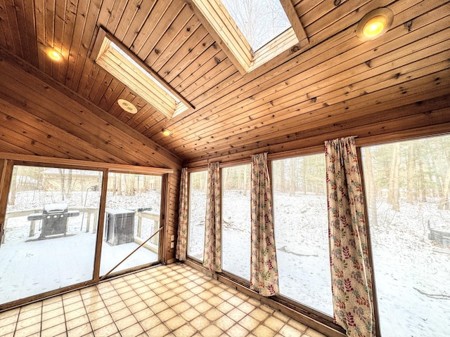 unfurnished sunroom with vaulted ceiling with skylight and wood ceiling