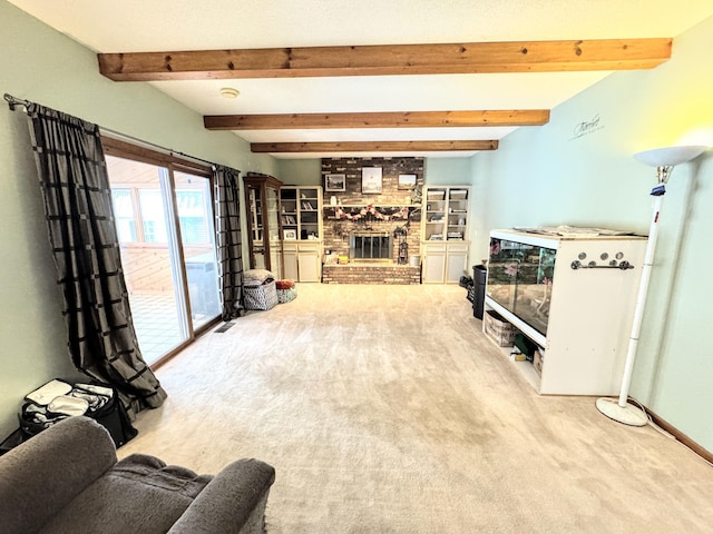 carpeted living room with beam ceiling and a brick fireplace