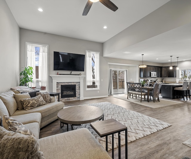 living room with light hardwood / wood-style floors and ceiling fan