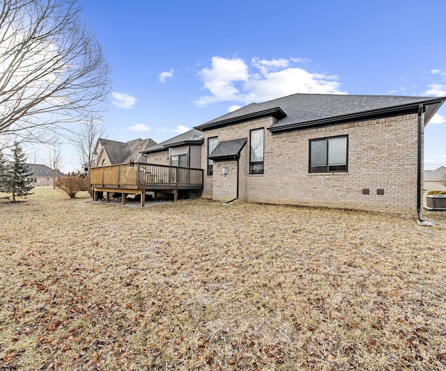 rear view of property featuring central AC unit and a deck