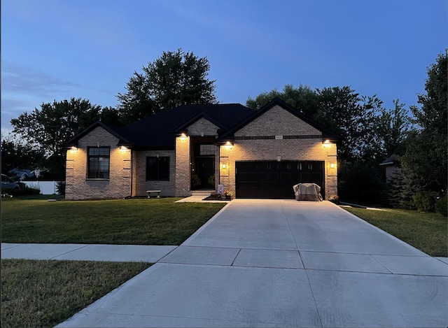 view of front of house featuring a garage and a lawn