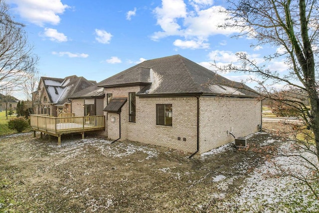 rear view of house featuring central AC unit and a deck