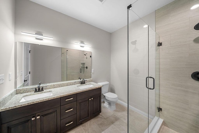 bathroom featuring vanity, toilet, and a shower with door