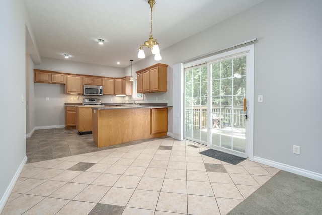 kitchen with kitchen peninsula, light tile patterned floors, a chandelier, and pendant lighting