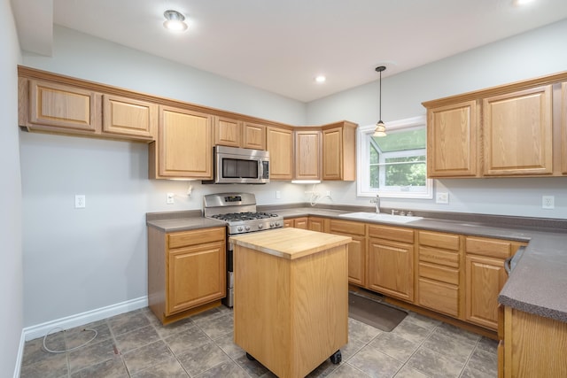 kitchen with butcher block counters, sink, a center island, hanging light fixtures, and appliances with stainless steel finishes