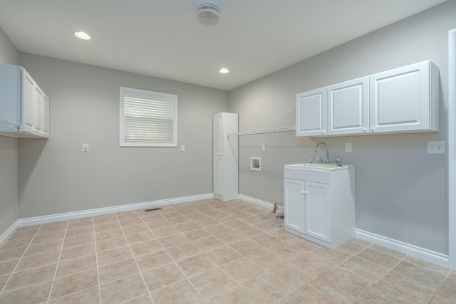 laundry area with hookup for a washing machine, light tile patterned floors, and sink