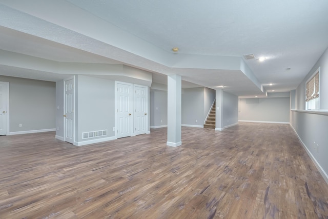 basement with hardwood / wood-style floors