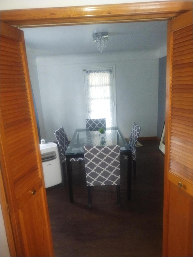 dining area featuring dark hardwood / wood-style floors and a notable chandelier