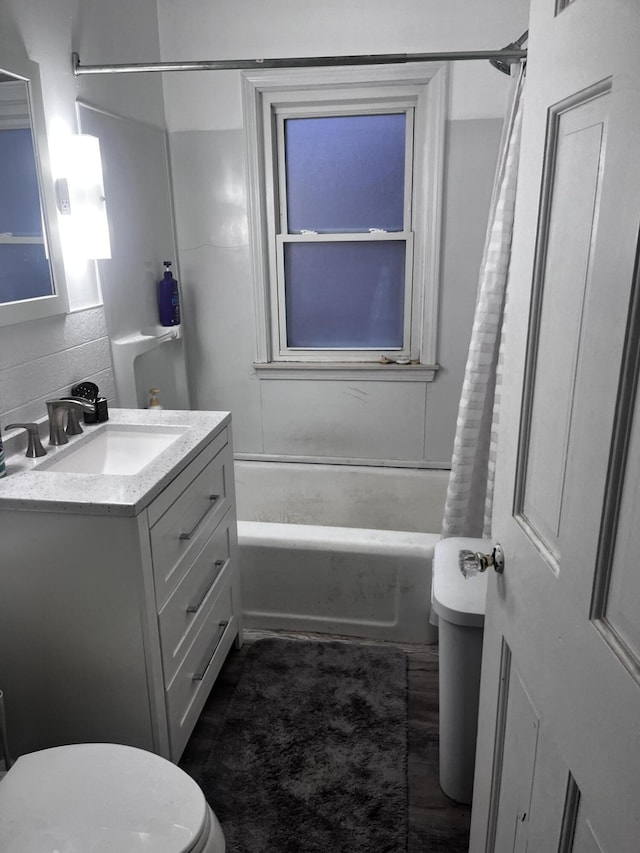 full bathroom featuring shower / bath combination with curtain, vanity, wood-type flooring, and toilet