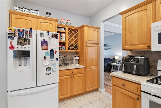 kitchen featuring backsplash, a textured ceiling, white appliances, light tile patterned floors, and ornamental molding