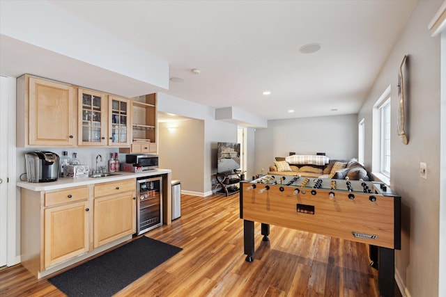 playroom with hardwood / wood-style floors, sink, and beverage cooler