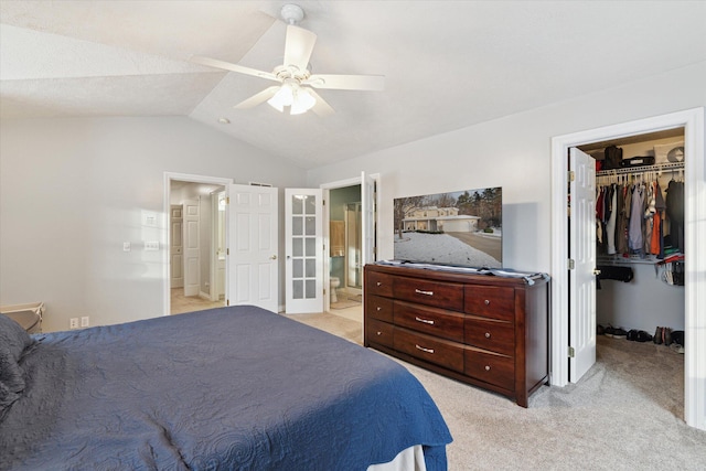 bedroom featuring lofted ceiling, light carpet, ceiling fan, connected bathroom, and a closet