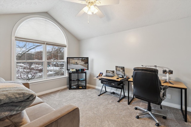 carpeted home office featuring ceiling fan and vaulted ceiling