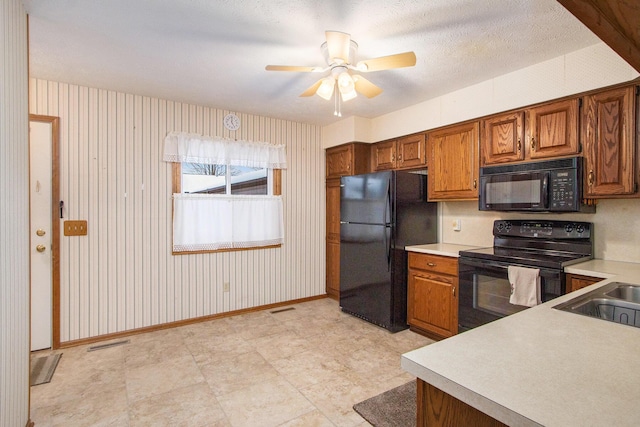 kitchen with sink, ceiling fan, and black appliances