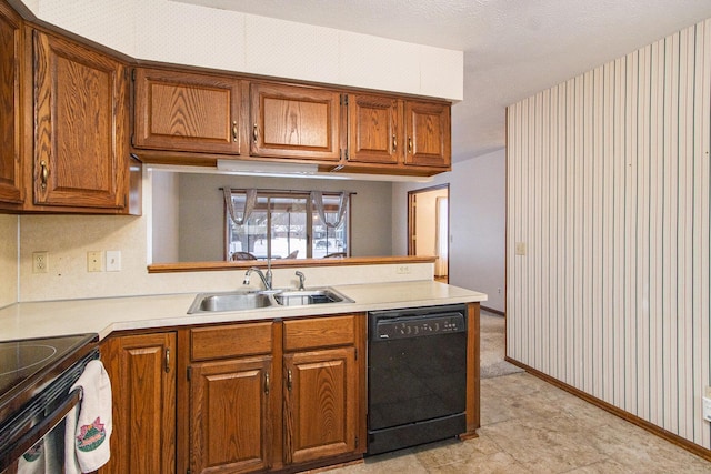 kitchen with black appliances, kitchen peninsula, and sink