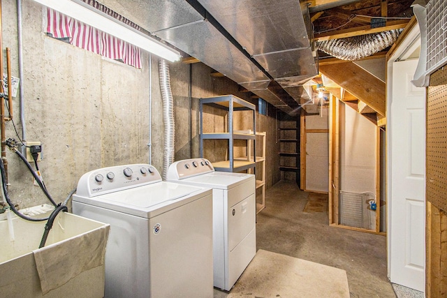 washroom with washing machine and clothes dryer and sink