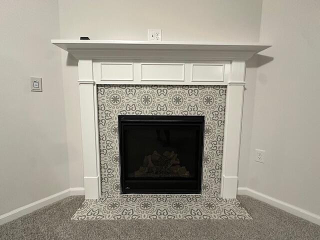 room details with carpet floors and a tiled fireplace