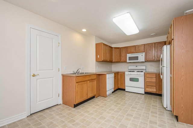 kitchen featuring sink and white appliances