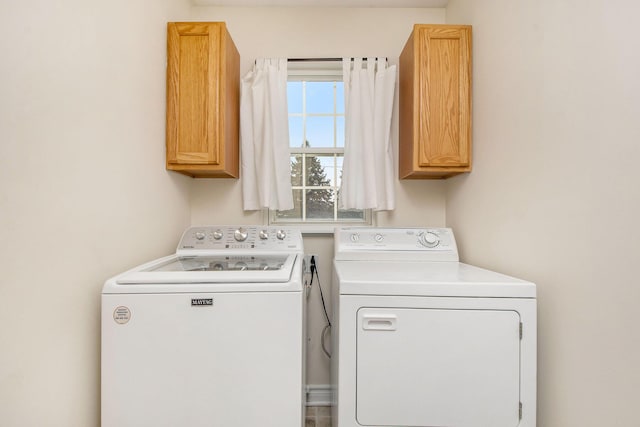 washroom with cabinets and separate washer and dryer