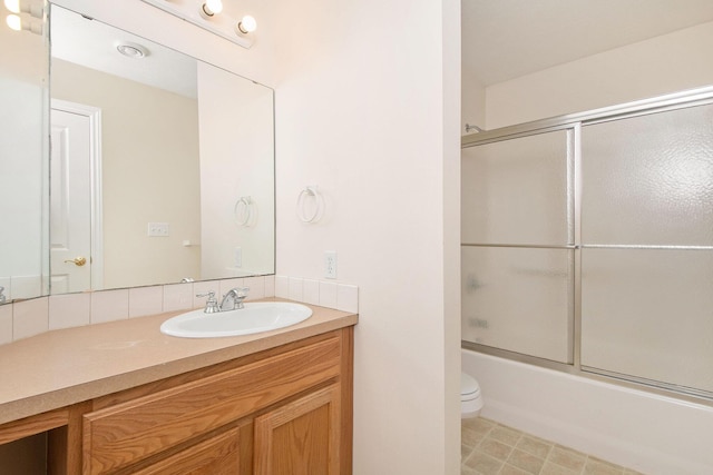 full bathroom with shower / bath combination with glass door, vanity, and toilet