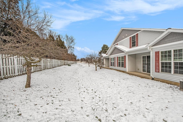 yard covered in snow with central AC unit