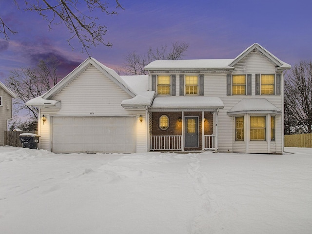 view of front of house featuring a garage and a porch