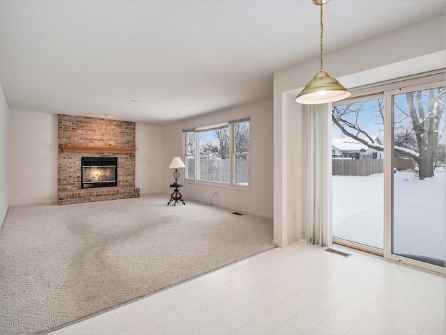 living room featuring a brick fireplace and carpet