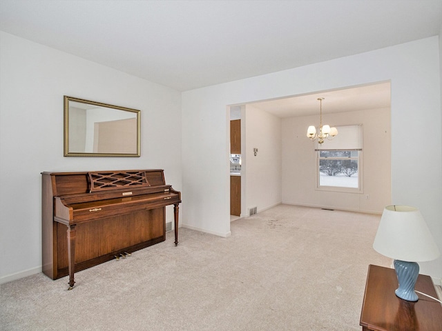 miscellaneous room featuring a notable chandelier and light colored carpet