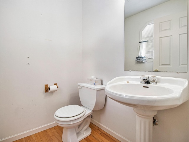 bathroom with toilet and wood-type flooring