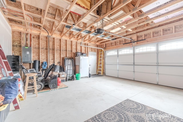 garage with electric panel, white fridge, and a garage door opener