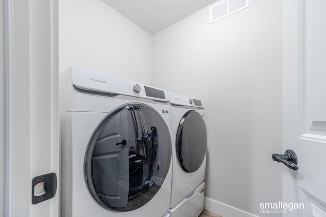 laundry area featuring washing machine and clothes dryer